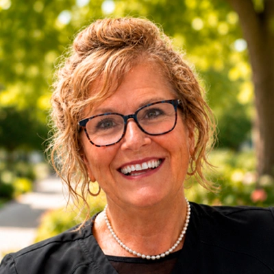 Outdoor headshot portrait of a person wearing glasses