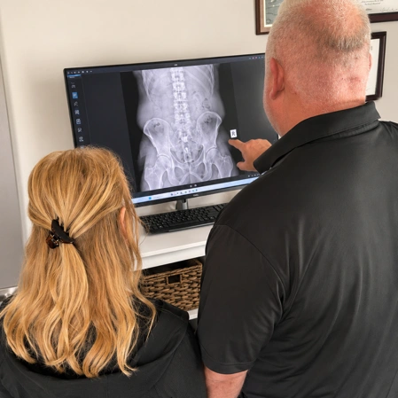 Practitioner and patient reviewing a pelvic X-ray