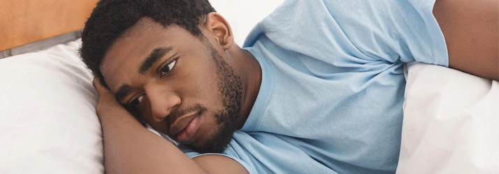 Close-up of a person lying on a bed